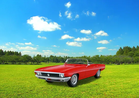 草原の中に、プロンプトで「赤いクラシックカー」と指示して生成した車が、まるで元からそこにあったかのように自然に配置されている